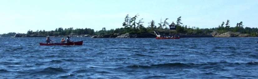 A war canoe and canoe from YMCA Camp Kitchekewana on Beausoleil Island