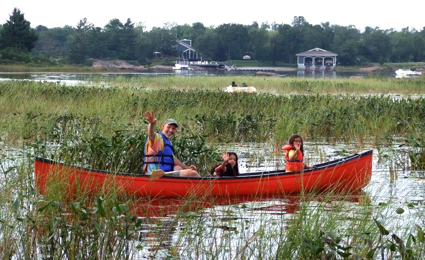 family canoeing at Elm Cove